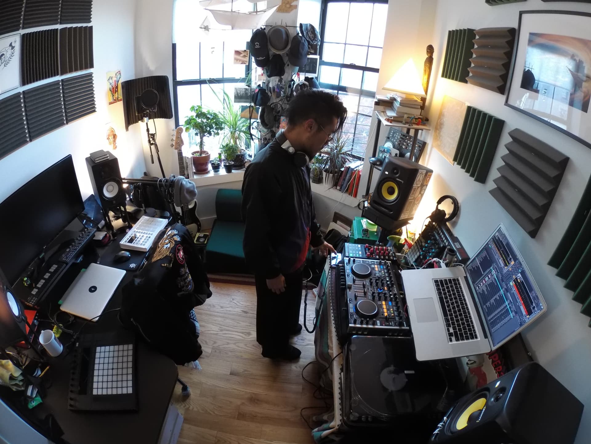 An older home studio — decks, mixers, speakers and records arranged around a small room