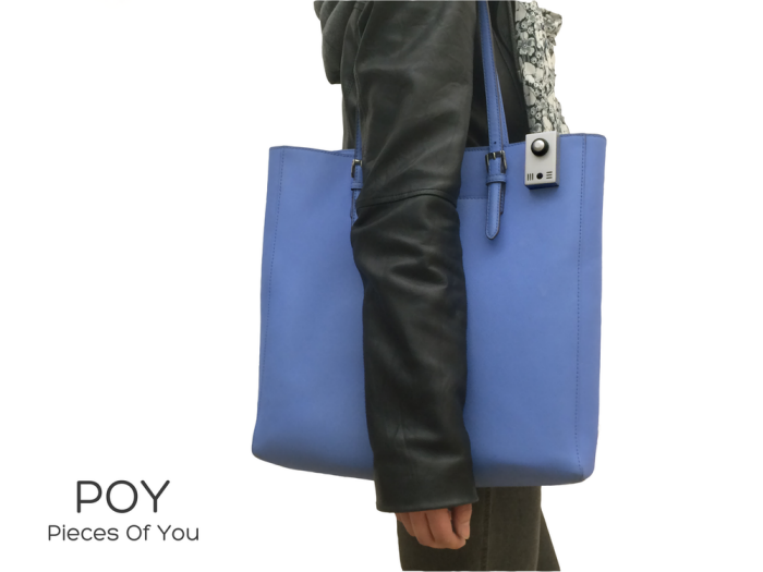 The POY Recorder clipped to the strap of a shoulder bag
