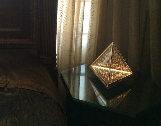 Symbol Lamp illuminated beside a window in a domestic interior