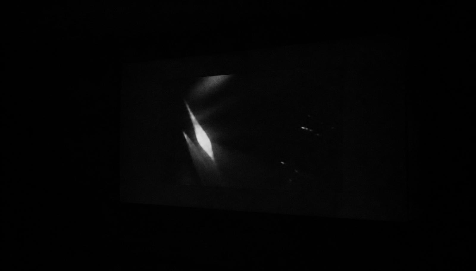 A faint projected image on a dark wall